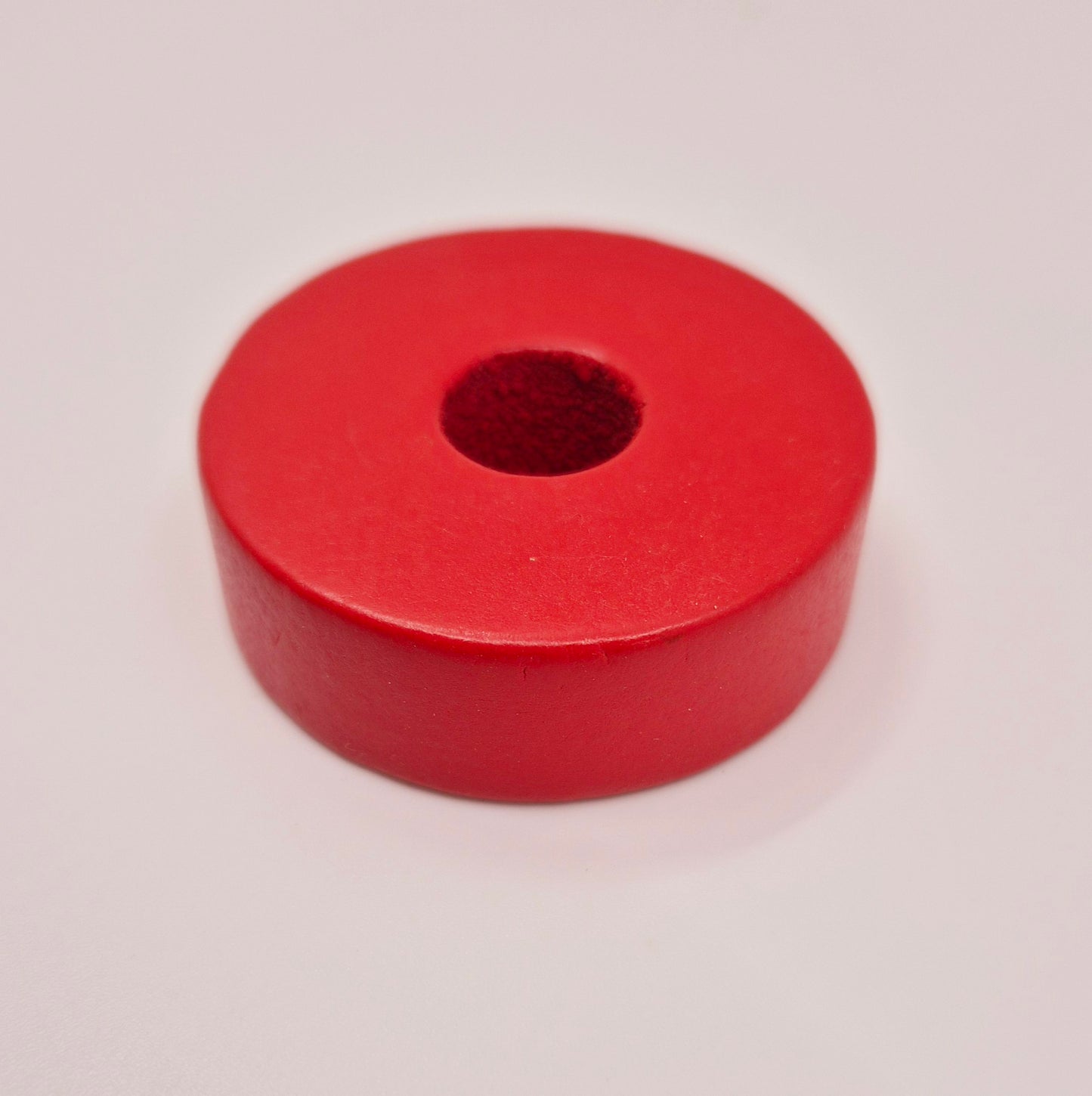 Red wooden disc with hole